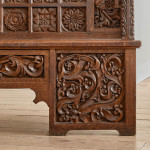 A fine Arts & Crafts carved oak settle in the manner of Bruce Talbert (1838 - 1881)