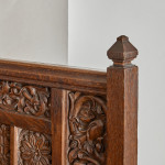 A fine Arts & Crafts carved oak settle in the manner of Bruce Talbert (1838 - 1881)