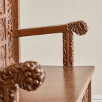 A fine Arts & Crafts carved oak settle in the manner of Bruce Talbert (1838 - 1881)