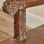 A fine Arts & Crafts carved oak settle in the manner of Bruce Talbert (1838 - 1881)