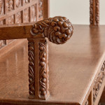 A fine Arts & Crafts carved oak settle in the manner of Bruce Talbert (1838 - 1881)