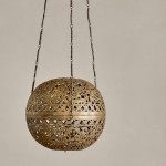 A brass shadow ball pendant