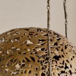 A brass shadow ball pendant