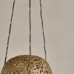 A brass shadow ball pendant