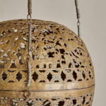 A brass shadow ball pendant