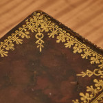 A small and fine George III leather and paper tea caddy