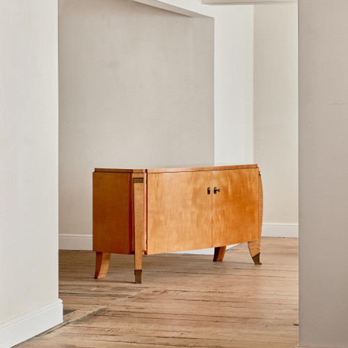 A large maple veneered commode by Maurice Rinck (1902 - 1983)