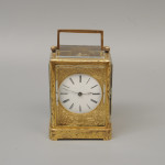 An early carriage clock in a gilt-engraved gorge case
