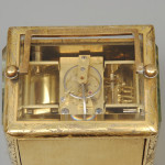 An early carriage clock in a gilt-engraved gorge case