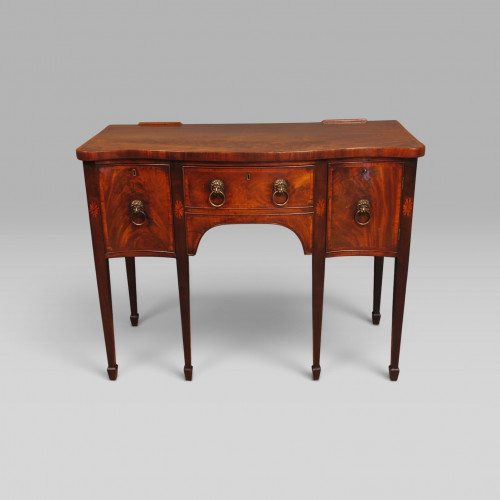 A fine small George III period mahogany serpentine sideboard