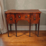 A fine small George III period mahogany serpentine sideboard