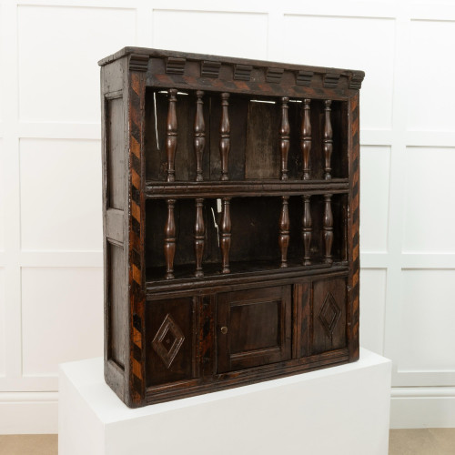 A Charles I oak and inlaid mural livery cupboard, circa 1640