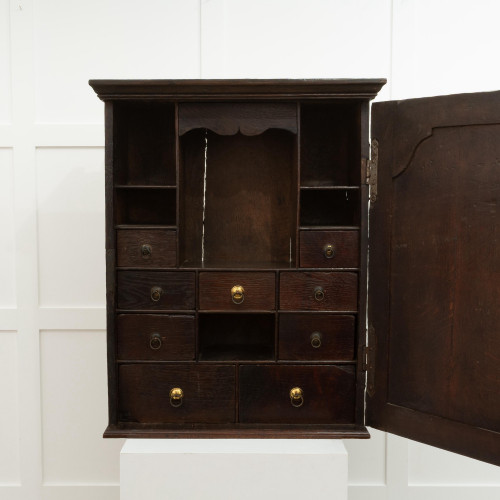 A George II oak mural spice cupboard, circa 1750