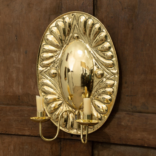 A brass repoussé-decorated wall sconce, in the 17th century manner, circa 1910