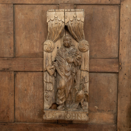 A carved oak panel depicting St. John, English, circa 1500-70