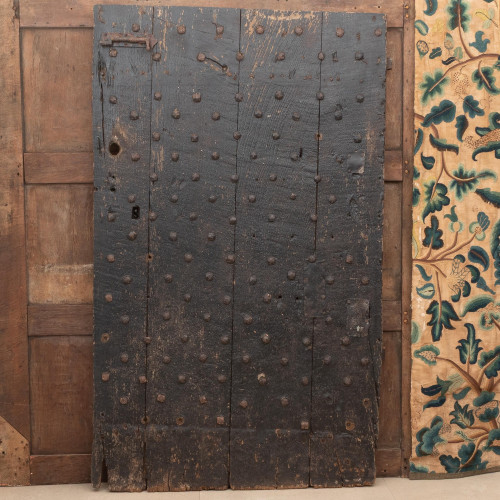 A rare mid-17th century vernacular oak and iron studded door, English, circa 1650 or possibly earlier