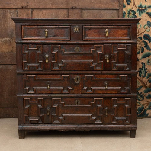 A Charles II geometric mitre-moulded oak chest of drawers