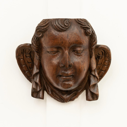 A late 16th century carved walnut angel mask, circa 1580