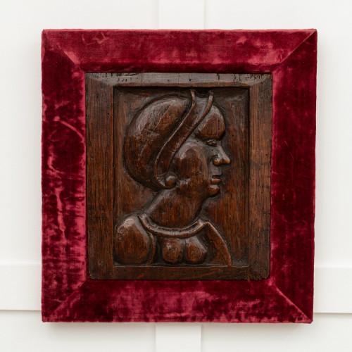 A Henry VIII carved oak portrait panel, circa 1520