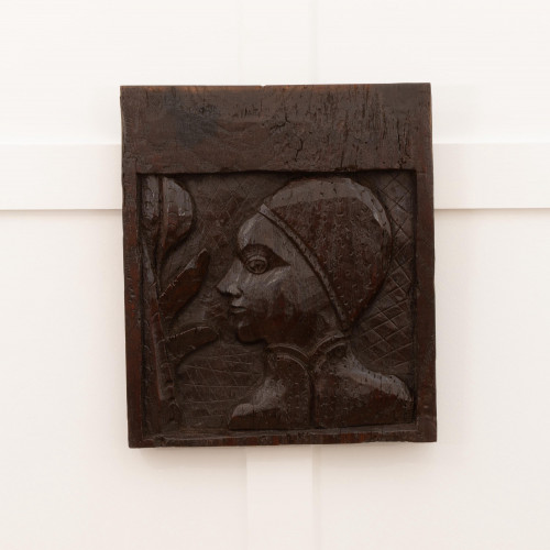 An unusual early Henry VIII carved oak portrait panel, circa 1510