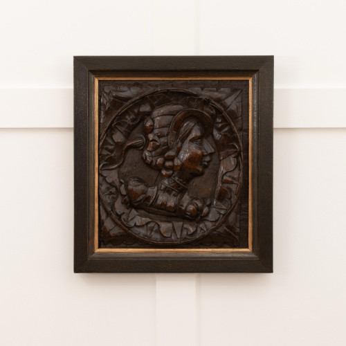 A Henry VIII carved oak portrait panel, circa 1530