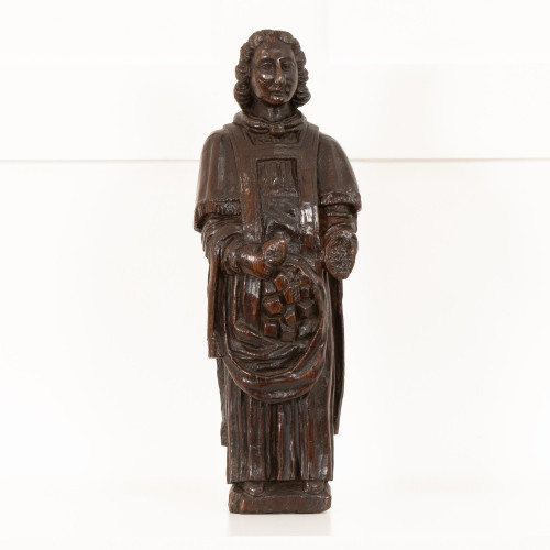 A tactile 15th century carved oak figure of a saint, probably English, East Anglican, circa 1420-60
