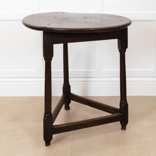 A George III one-piece elm top and joined oak cricket 'tavern' table, circa 1760