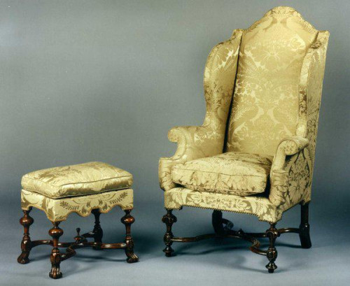 A rare William & Mary Walnut Wing Armchair & stool upholstered in a silk damask