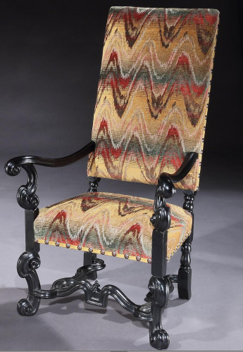 AN UNUSUAL, BAROQUE, EBONISED BEECH ARMCHAIR WITH FORTY-FIVE DEGREE ELBOWS AND FEET AND TRANSITIONAL FEATURES