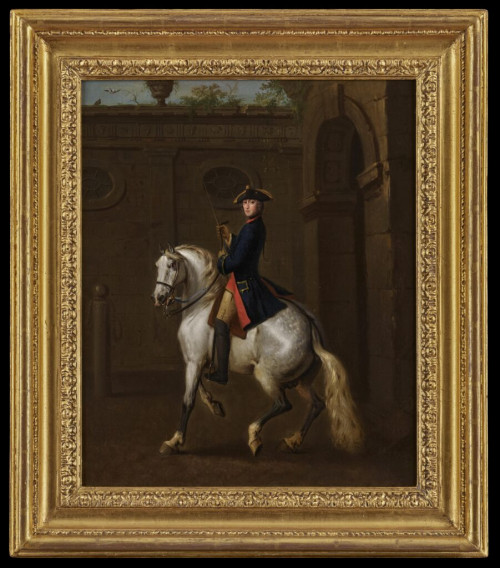An equestrian portrait of a gentleman, believed to be Sir Hew Dalrymple 2nd Baronet Lord Drummore, in a blue coat and gold-trimmed tricorn hat, mounted on a grey horse in a courtyard