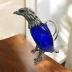 Victorian style silver plated claret jug in the form of a standing eagle (blue glass)