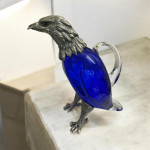 Victorian style silver plated claret jug in the form of a standing eagle (blue glass)