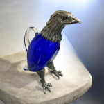 Victorian style silver plated claret jug in the form of a standing eagle (blue glass)