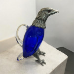 Victorian style silver plated claret jug in the form of a standing eagle (blue glass)