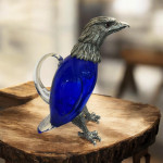 Victorian style silver plated claret jug in the form of a standing eagle (blue glass)