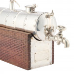 A CONTINENTAL SILVER NOVELTY DECANTER
CIRCA 1900 IN THE FORM OF A STEAM ENGINE BOILER