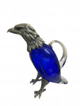 Victorian style silver plated claret jug in the form of a standing eagle (blue glass)