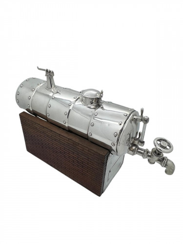 A CONTINENTAL SILVER NOVELTY DECANTER
CIRCA 1900 IN THE FORM OF A STEAM ENGINE BOILER