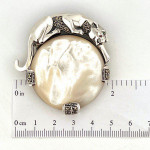 Sterling Silver Panther Brooch in an Art Deco Style With Mother Of Pearl Marcasite And Emerald Eyes