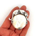 Sterling Silver Panther Brooch in an Art Deco Style With Mother Of Pearl Marcasite And Emerald Eyes