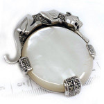 Sterling Silver Panther Brooch in an Art Deco Style With Mother Of Pearl Marcasite And Emerald Eyes