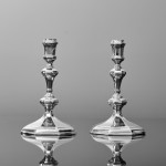 Pair of Queen Anne cast Britannia silver candlesticks