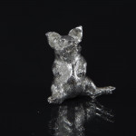 Silver pig sitting up