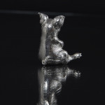 Silver pig sitting up