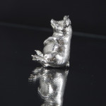 Silver pig sitting up