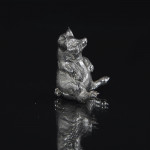 Silver pig sitting up