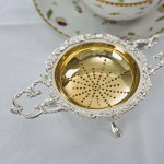 Two-handled sterling silver tea strainer & drip bowl