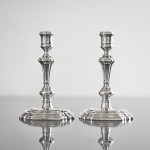 Pair of George II cast silver candlesticks