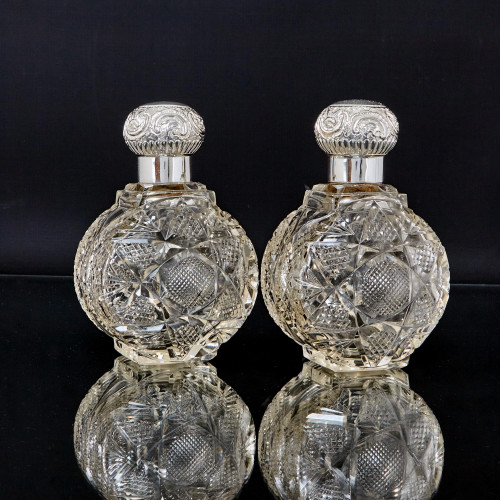 Pair of large Victorian cut glass & sterling-silver-mounted perfume bottles