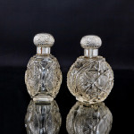 Pair of large Victorian cut glass & sterling-silver-mounted perfume bottles